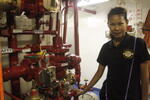 Navy League member Rin inspecting fire-control equipment