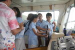 Students at the helm of the taxi boat